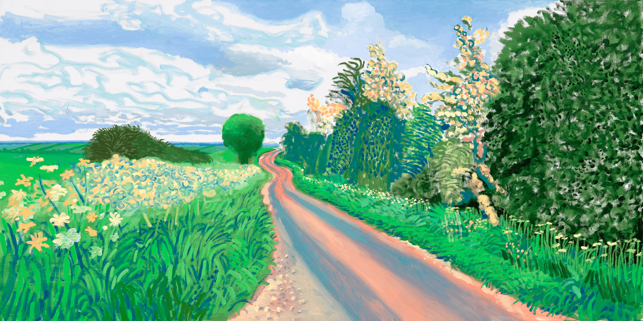 A winding country road bordered by tall green hedges and wildflowers stretches into the distance under a partly cloudy sky, creating a peaceful rural landscape.